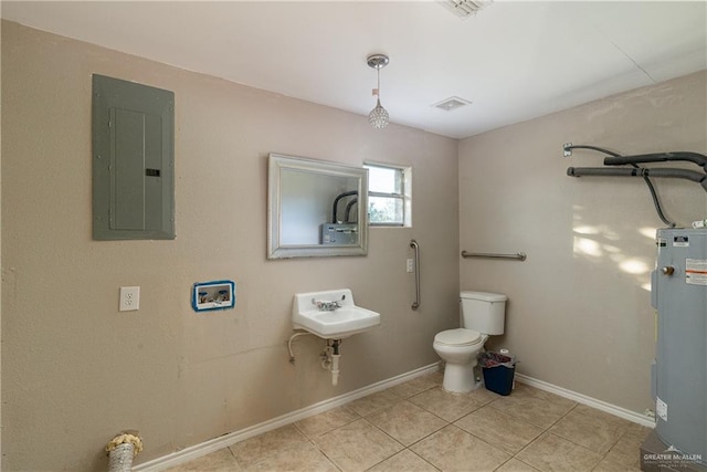 bathroom featuring electric water heater, toilet, tile patterned floors, electric panel, and sink