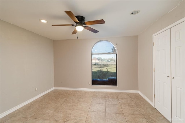 spare room featuring ceiling fan and light tile patterned floors