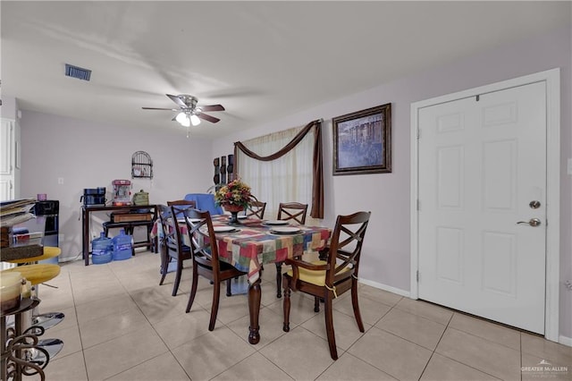 dining area with light tile patterned floors and ceiling fan