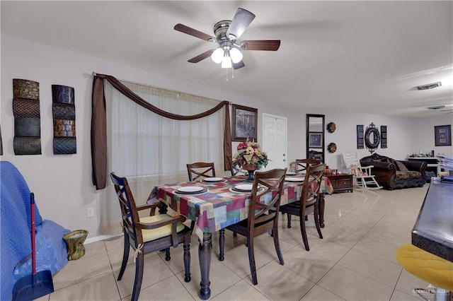 dining space featuring ceiling fan and light tile patterned floors