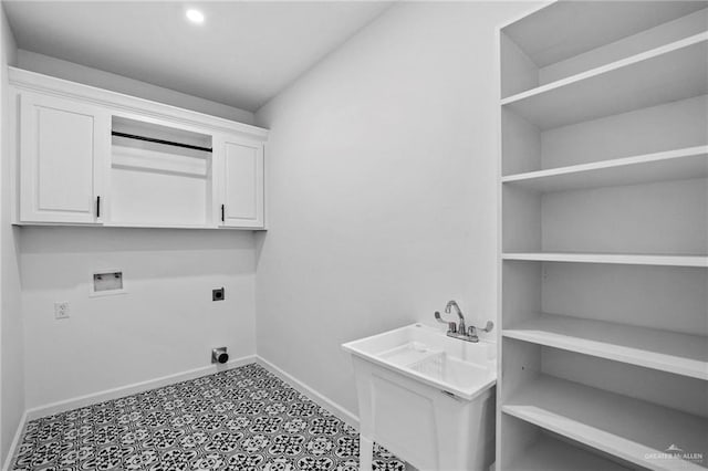 laundry area with cabinets, hookup for a washing machine, and hookup for an electric dryer