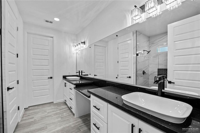 bathroom featuring an enclosed shower and vanity