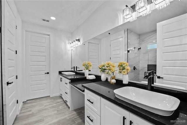 bathroom featuring vanity and a shower with shower door