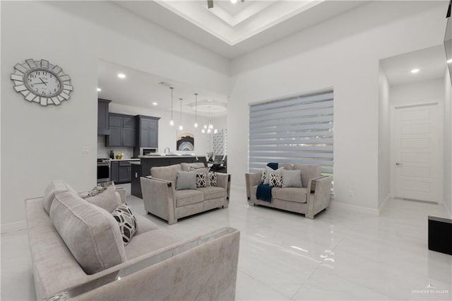 1213 N Garden Ridge Ave, San Juan, TX 78589 - living room with recessed lighting, baseboards, a high ceiling, and a tray ceiling