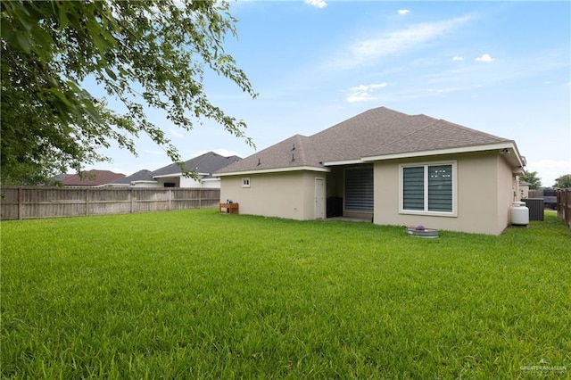 1213 N Garden Ridge Ave, San Juan, TX 78589 - back of property featuring stucco siding, a shingled roof, and central AC unit
