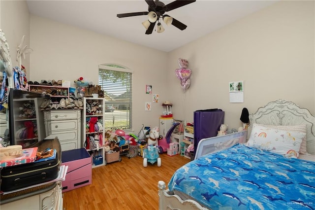 bedroom with a ceiling fan and wood finished floors
