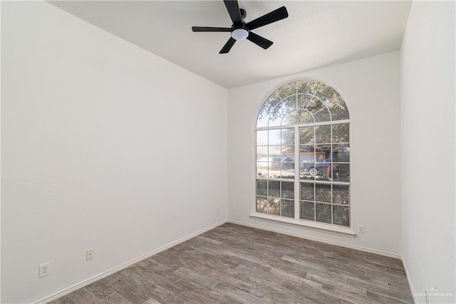 spare room featuring ceiling fan, baseboards, and wood finished floors