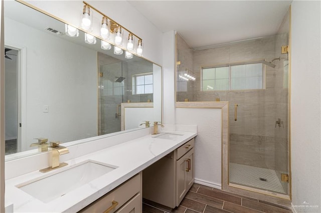 full bath with a sink, visible vents, wood finish floors, and a stall shower