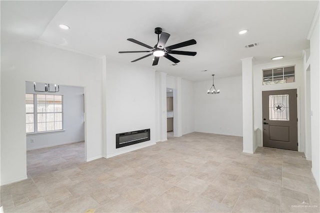 unfurnished living room featuring visible vents, ceiling fan with notable chandelier, a glass covered fireplace, recessed lighting, and baseboards