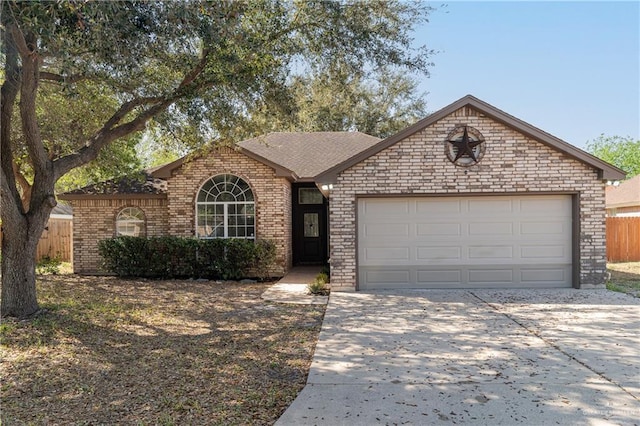 ranch-style house with a garage, brick siding, concrete driveway, and fence