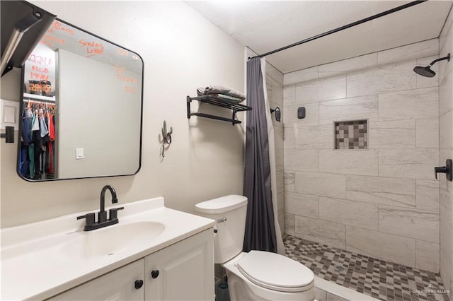 bathroom featuring a shower with curtain, vanity, and toilet