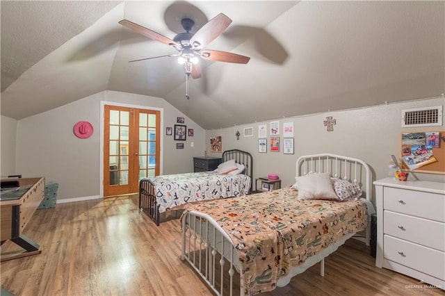 bedroom featuring french doors, light wood-type flooring, ceiling fan, and lofted ceiling