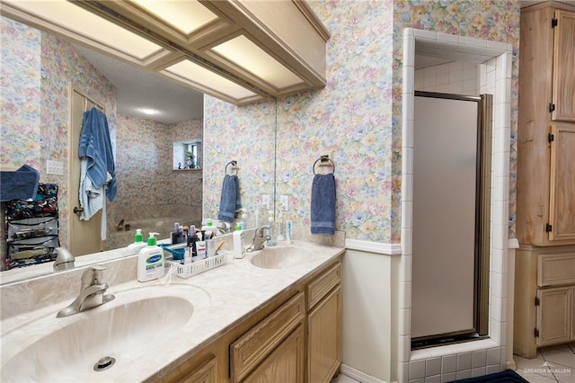 bathroom with tile patterned floors, a shower with door, and vanity