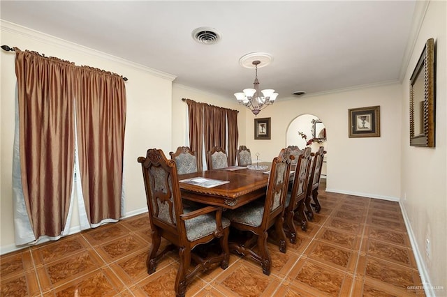 dining room with a chandelier, tile patterned floors, and crown molding