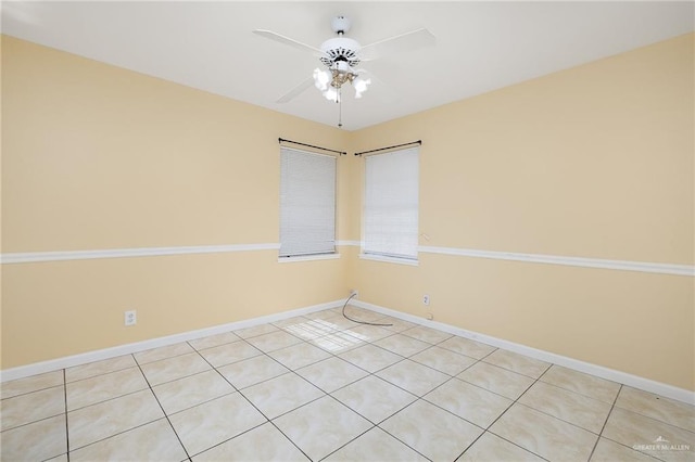 tiled spare room featuring ceiling fan