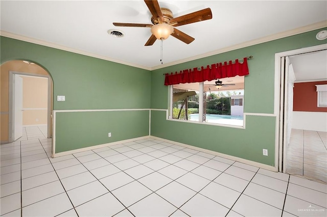 tiled empty room with ceiling fan and crown molding