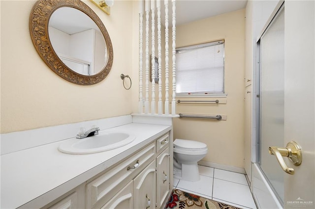 full bathroom featuring tile patterned flooring, vanity, toilet, and enclosed tub / shower combo