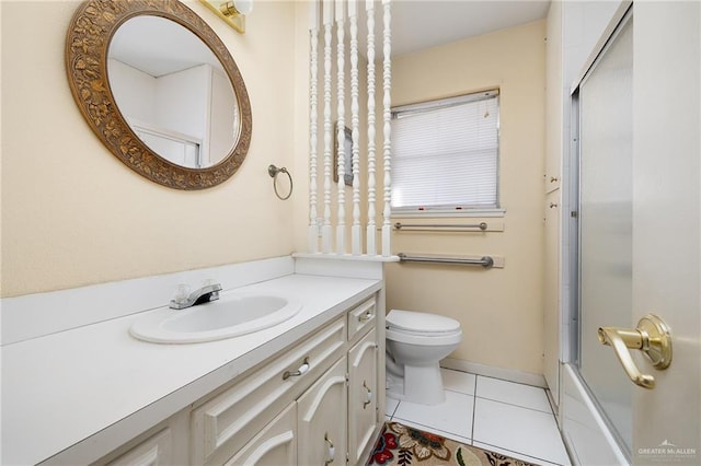 1201 W Fern Ave, Mcallen, TX 78501 - bathroom with vanity, tile patterned floors, toilet, bath / shower combo with glass door, and baseboards