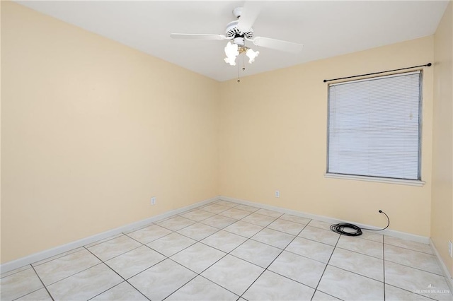 empty room featuring ceiling fan and light tile patterned flooring