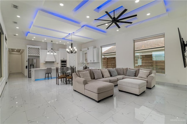 living room featuring baseboards, marble finish floor, a tray ceiling, and recessed lighting