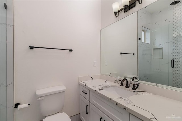 bathroom with toilet, a marble finish shower, and vanity