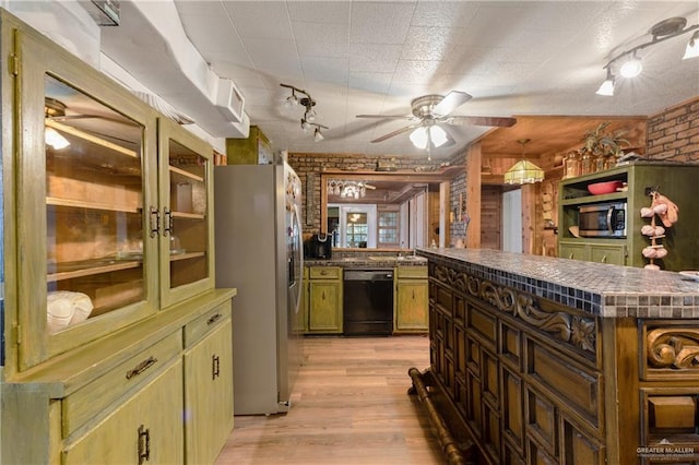 kitchen with ceiling fan, stainless steel appliances, brick wall, kitchen peninsula, and light wood-type flooring