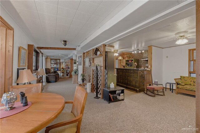 dining space featuring ceiling fan and light colored carpet