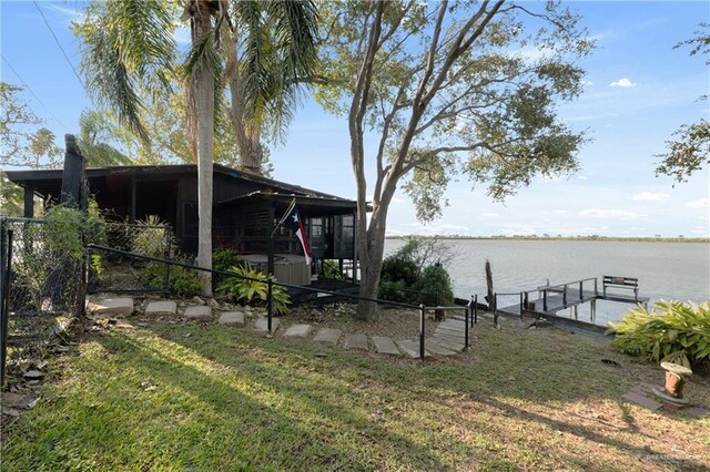 view of yard featuring a boat dock and a water view