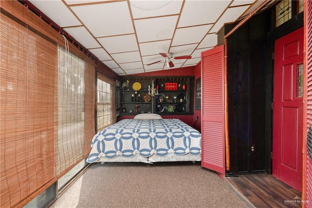 unfurnished bedroom featuring wood walls, dark hardwood / wood-style flooring, and lofted ceiling