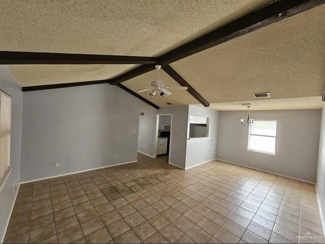 unfurnished living room with ceiling fan with notable chandelier, vaulted ceiling with beams, a textured ceiling, and tile patterned floors