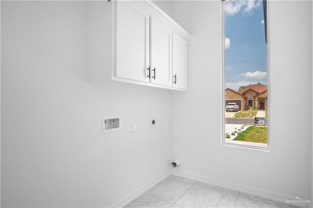 1506 N Rockport St, Alton, TX 78573 - laundry room featuring electric dryer hookup, cabinet space, light marble finish flooring, baseboards, and hookup for a washing machine
