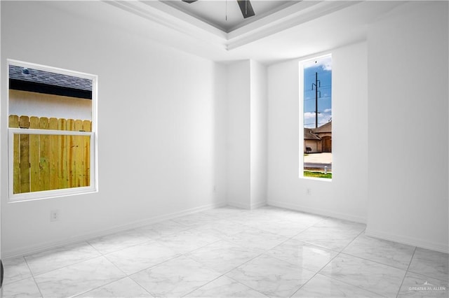 1506 N Rockport St, Alton, TX 78573 - unfurnished room featuring marble finish floors, a tray ceiling, and a ceiling fan