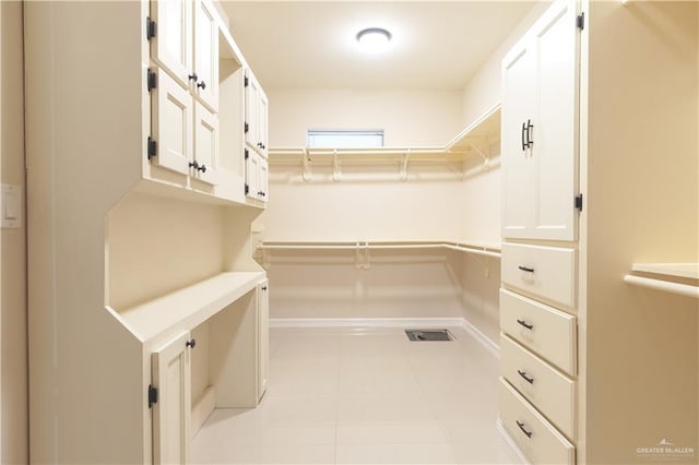 spacious closet with light tile patterned flooring