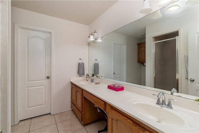 bathroom with vanity, a shower with door, and tile patterned floors