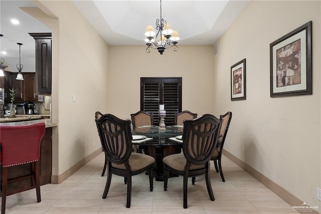 dining space with light tile patterned floors and a notable chandelier