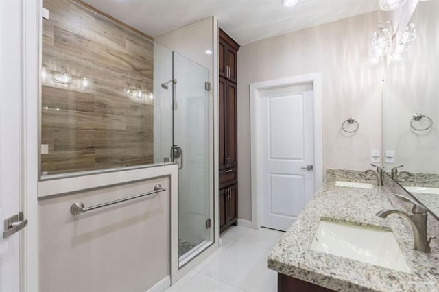 bathroom featuring tile patterned flooring, vanity, and walk in shower