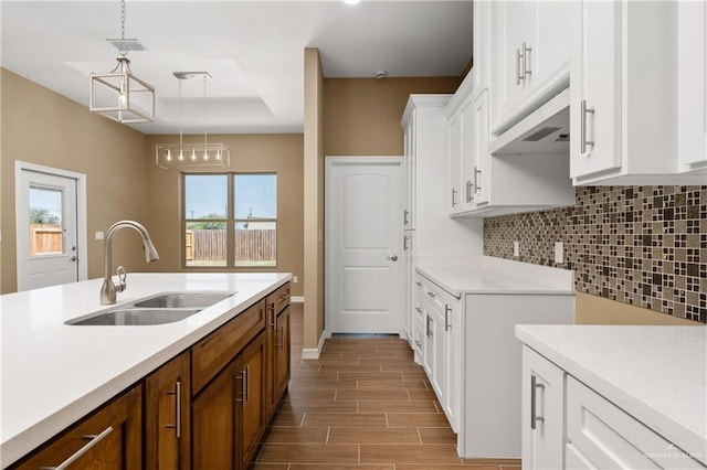 3311 Las Vistas Ln, Weslaco, TX 78596 - kitchen featuring a sink, tasteful backsplash, light countertops, white cabinets, and light wood-style flooring