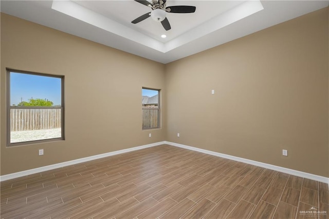 3311 Las Vistas Ln, Weslaco, TX 78596 - empty room featuring baseboards, a tray ceiling, healthy amount of natural light, ceiling fan, and recessed lighting