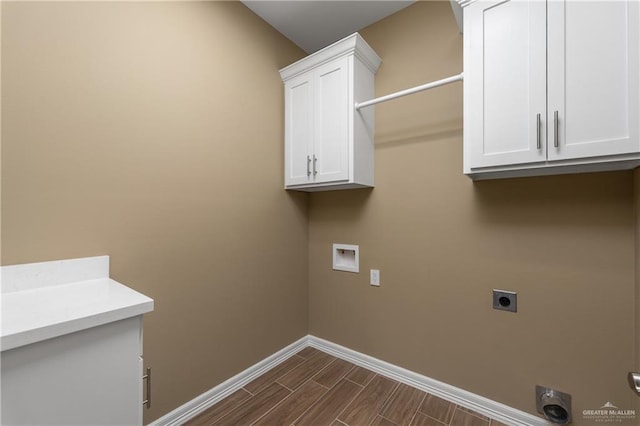 3311 Las Vistas Ln, Weslaco, TX 78596 - washroom with hookup for an electric dryer, baseboards, cabinet space, wood tiled floors, and hookup for a washing machine