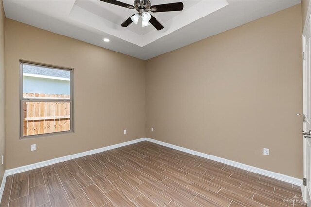3311 Las Vistas Ln, Weslaco, TX 78596 - unfurnished room featuring a tray ceiling, baseboards, a ceiling fan, and recessed lighting