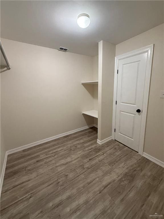 walk in closet featuring visible vents and wood finished floors