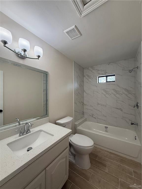 full bath featuring toilet, wood finish floors, vanity, visible vents, and washtub / shower combination