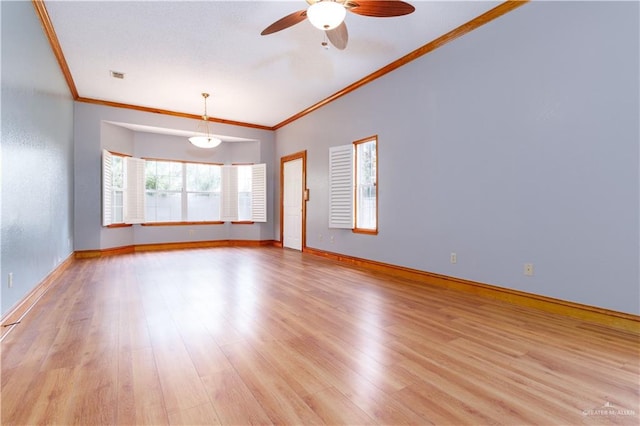 empty room featuring ceiling fan, ornamental molding, and light hardwood / wood-style flooring