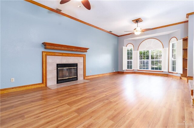 unfurnished living room with a fireplace, crown molding, light hardwood / wood-style flooring, and ceiling fan