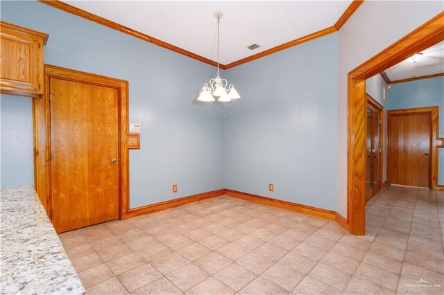 spare room with ornamental molding and a chandelier