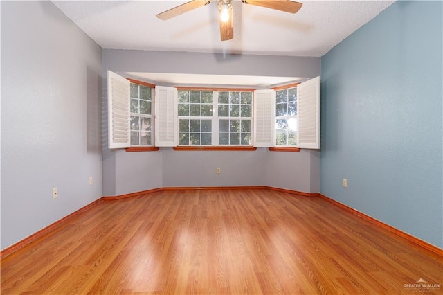 unfurnished room featuring ceiling fan and light hardwood / wood-style floors