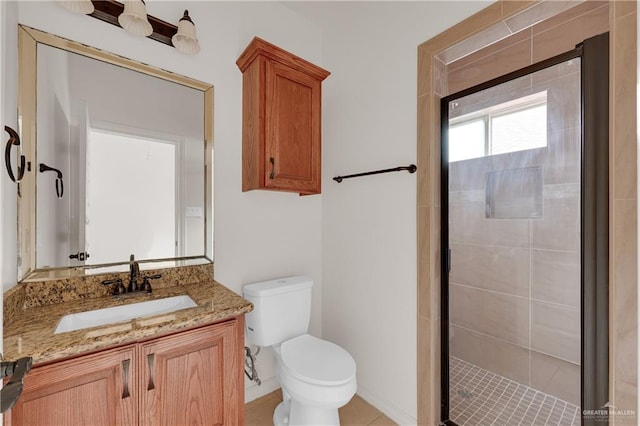 bathroom with vanity, toilet, and a shower with door