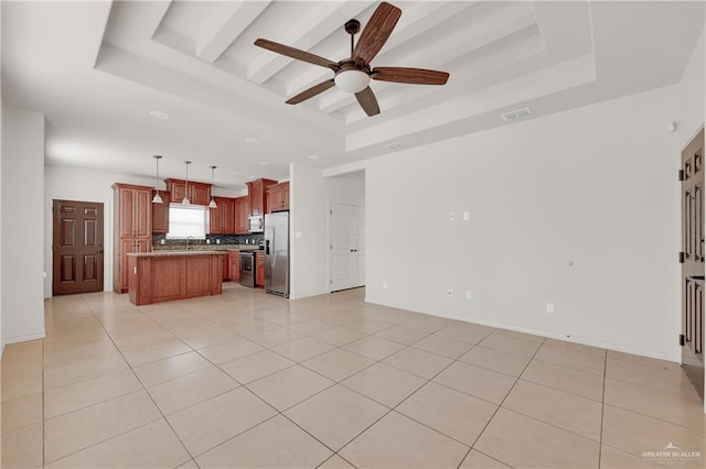 unfurnished living room featuring sink, a raised ceiling, ceiling fan, and light tile patterned flooring