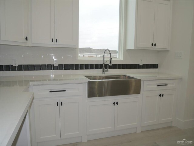 3309 S Marla Ct, Edinburg, TX 78542 - kitchen featuring a sink, white cabinets, and light countertops