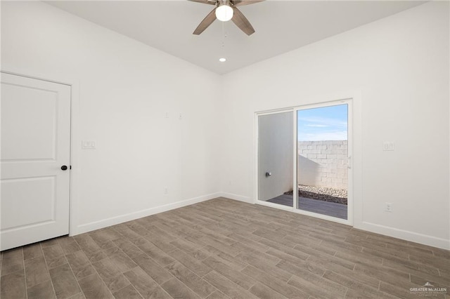 empty room with ceiling fan and light hardwood / wood-style flooring